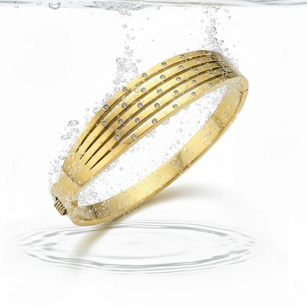 Gold bracelet with small stones on a white background