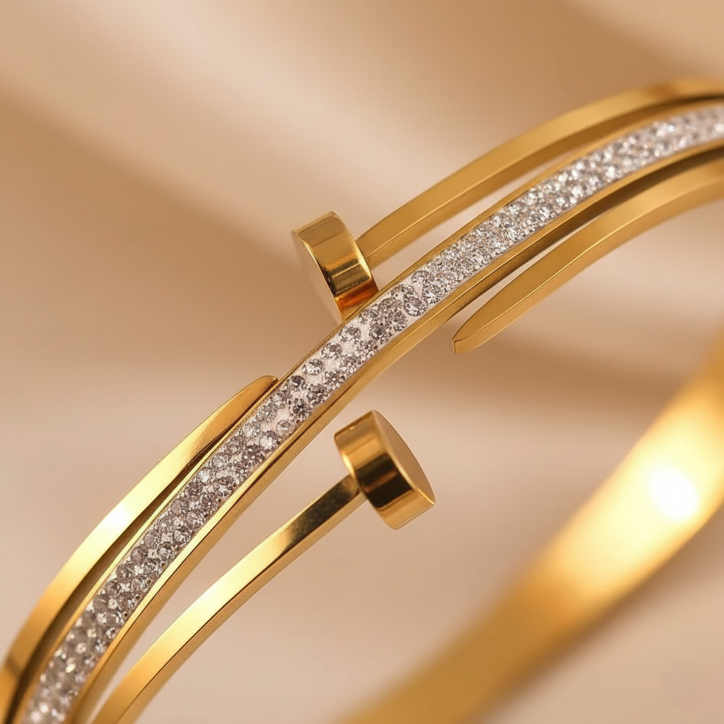 Gold bracelet with diamond accents on a beige background