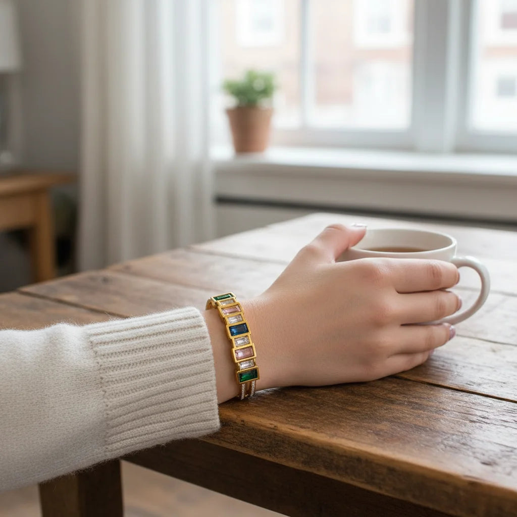 Hand holding a mug on a wooden table with a blurred indoor background