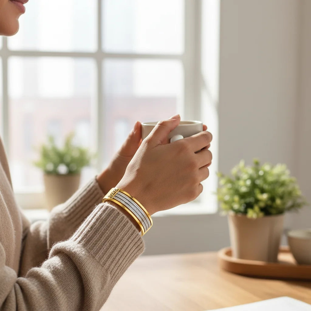Person holding a mug with a blurred indoor background