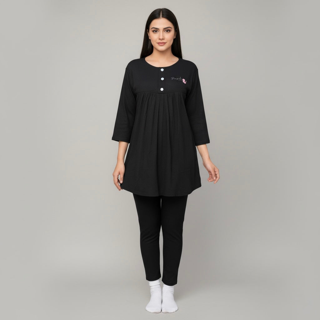 Woman wearing a black outfit with a plain background