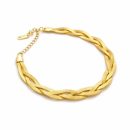 Gold braided necklace on a white background