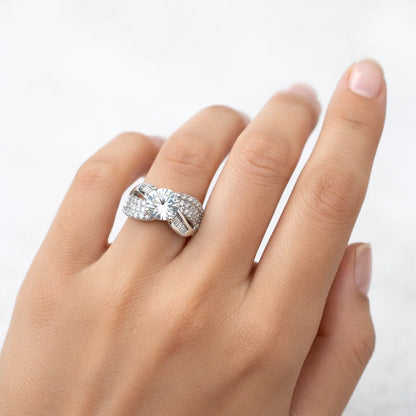 Silver ring with a large diamond on a hand against a white background