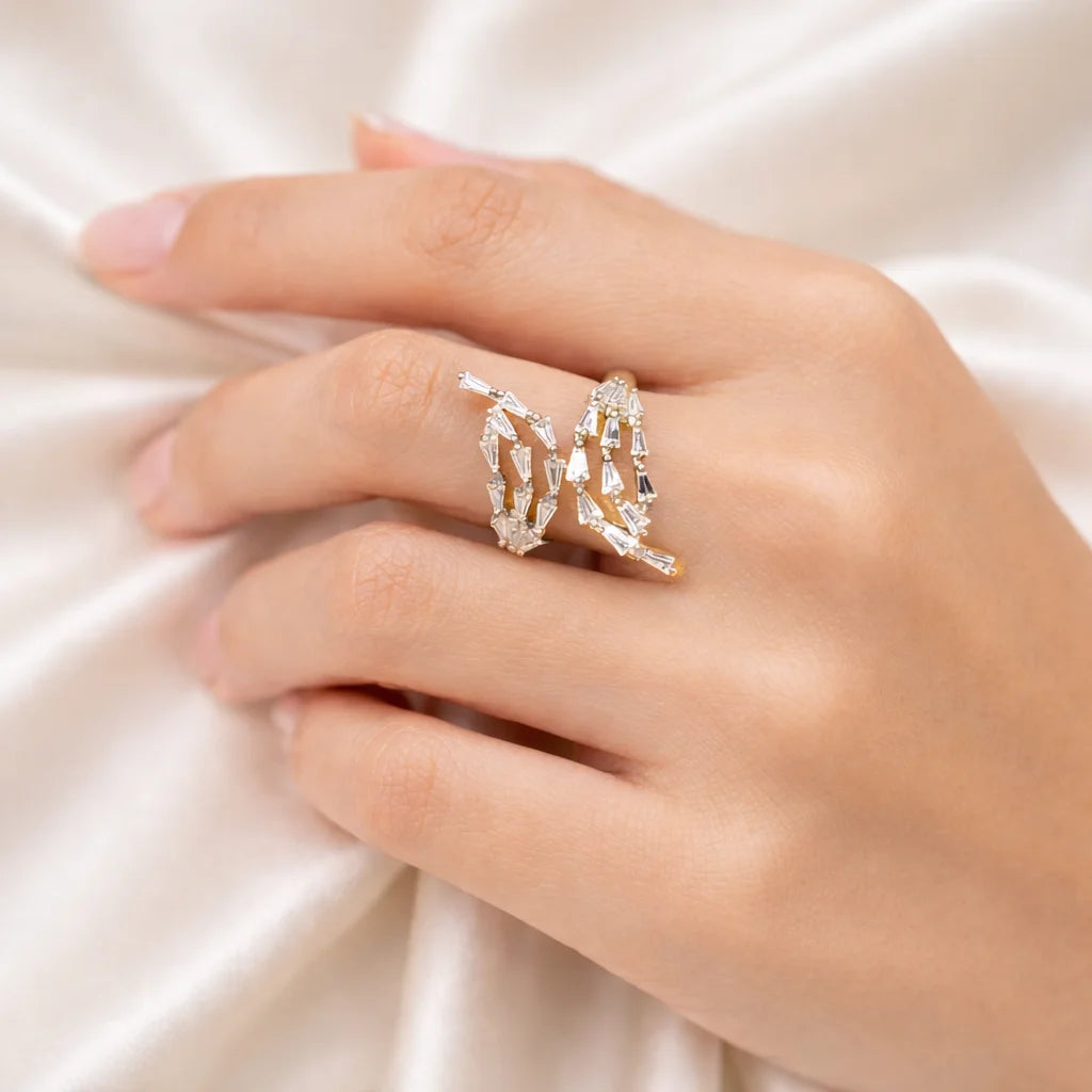 Hand wearing a decorative ring on a soft fabric background