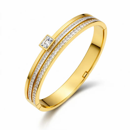 Gold ring with diamond accents on a white background