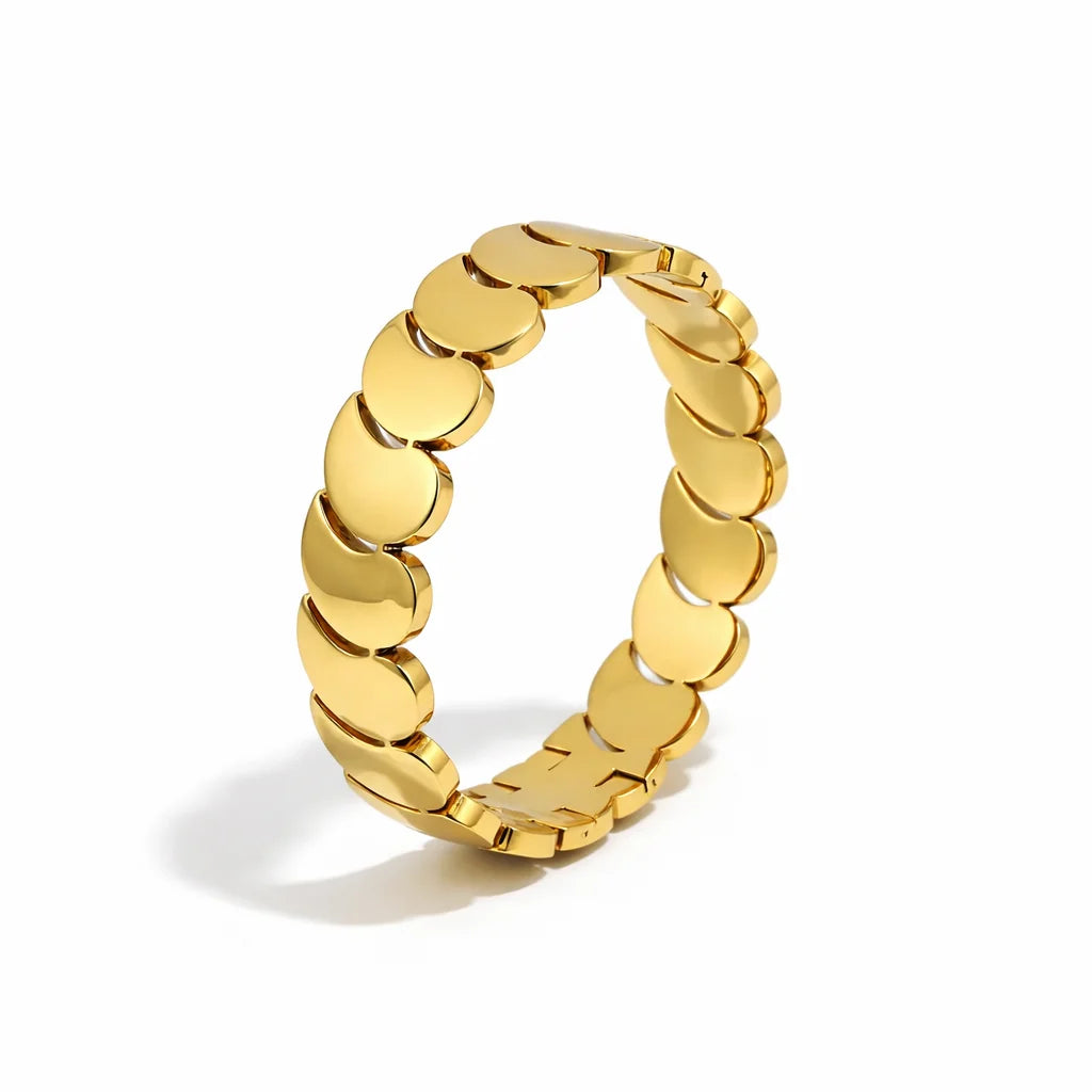 Gold chain-style ring on a white background