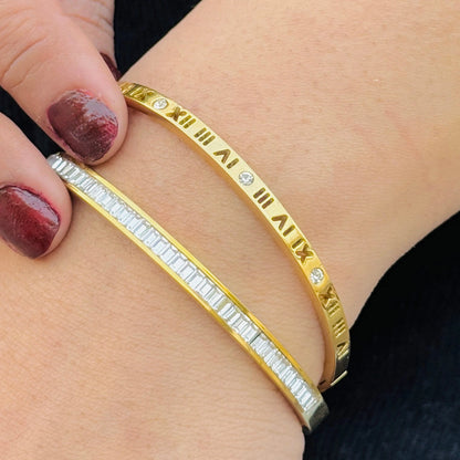 Gold bracelet with diamond accents on a wrist