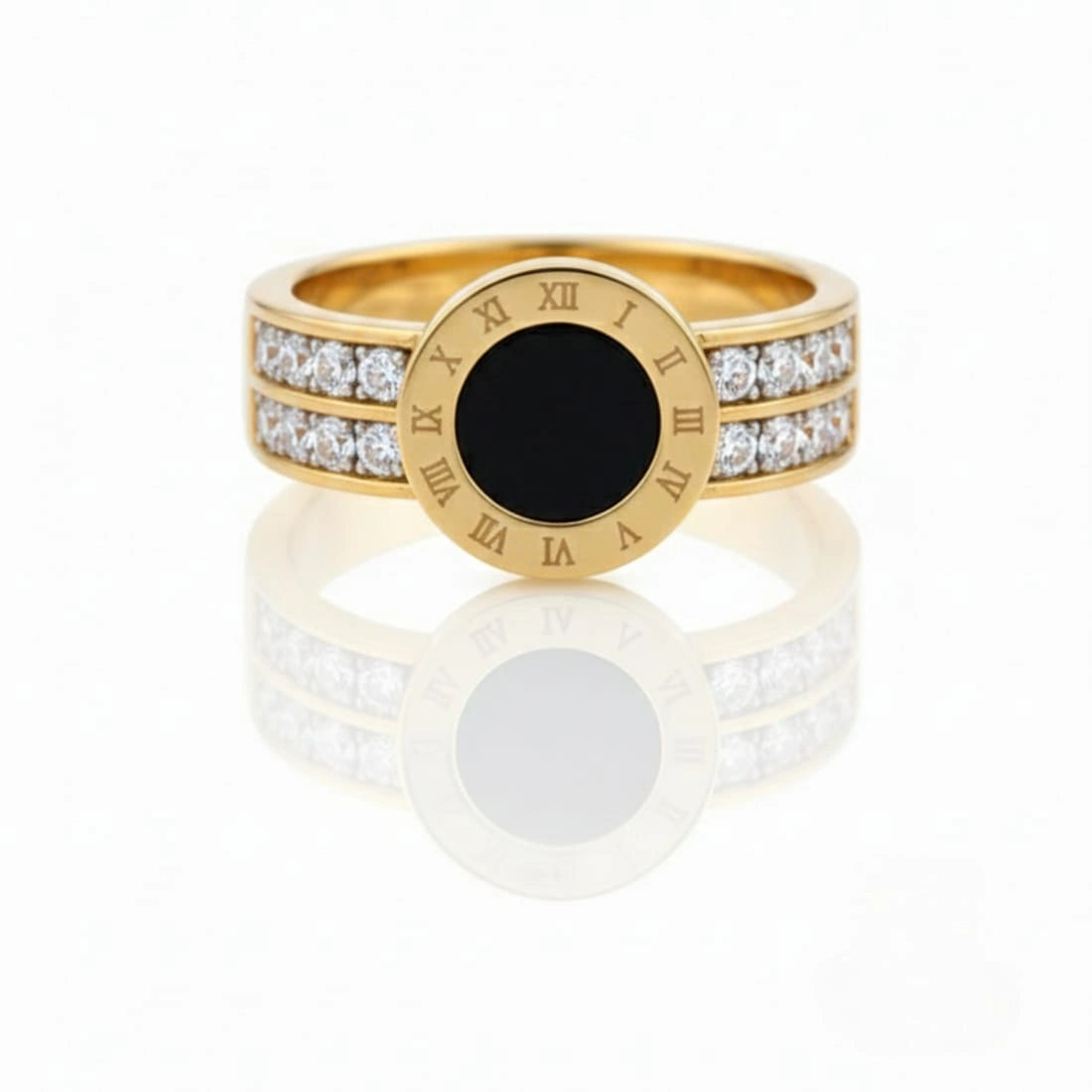 Gold ring with black center and diamond accents on a white background