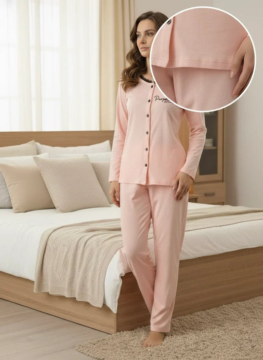 Woman in soft pink cotton pajamas standing by a cozy bed in a modern bedroom