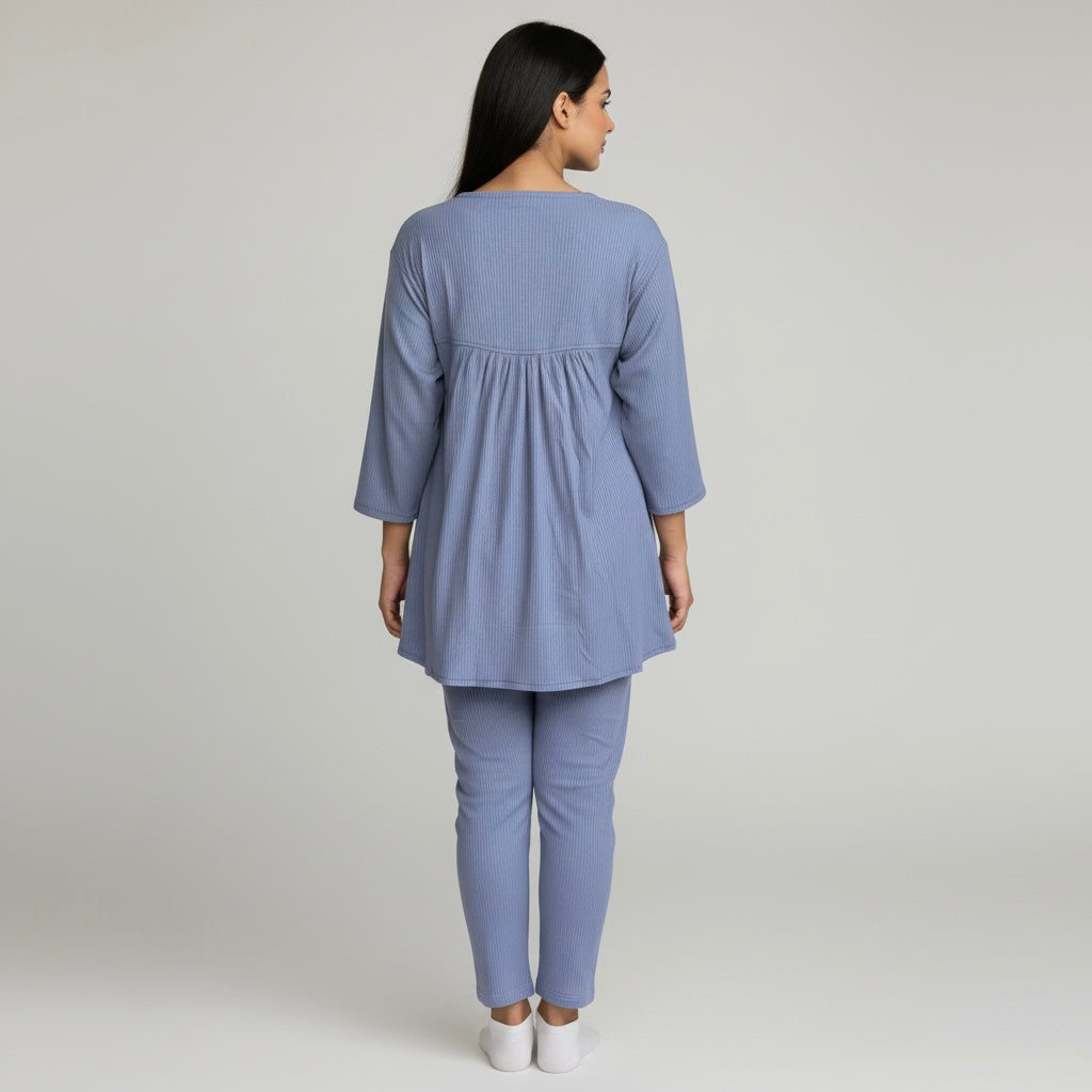 Woman wearing a light blue outfit on a plain background