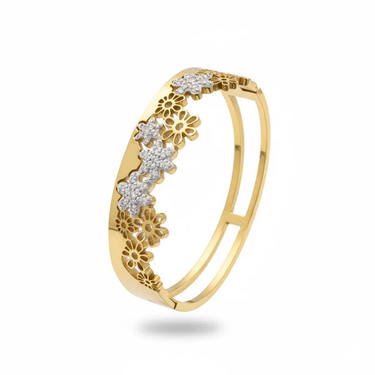 Gold ring with floral designs and diamonds on a white background