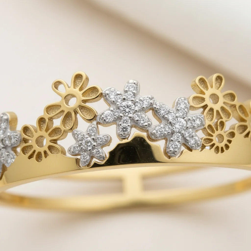 Gold bracelet with floral designs and embedded diamonds on a beige background