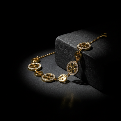 Gold necklace with gear-like design on a dark background