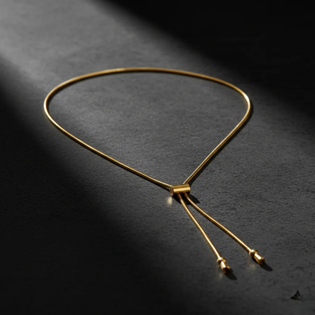 Gold necklace on a dark textured surface