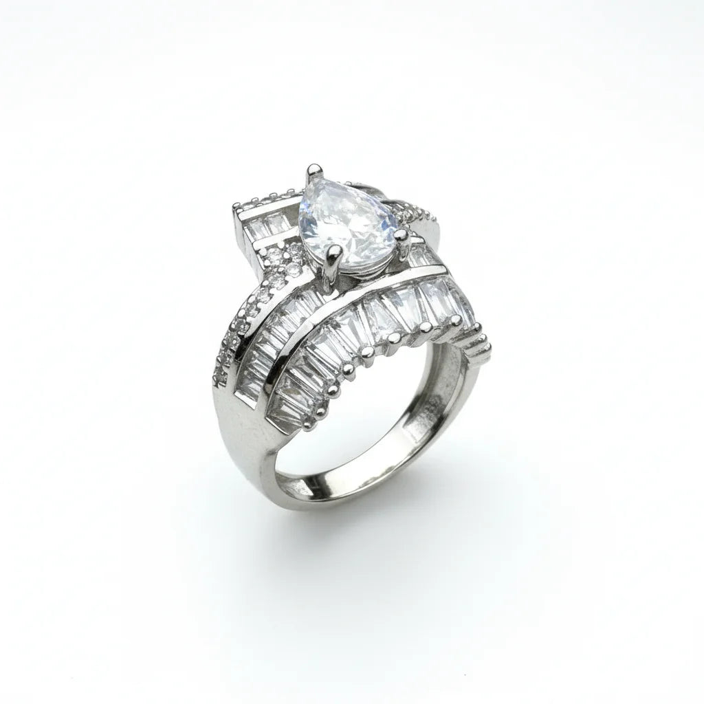 Silver ring with a large central diamond and smaller baguette-cut diamonds on a white background