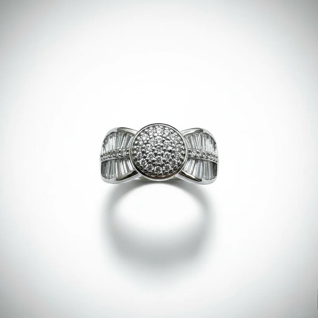 Silver ring with diamond accents on a light gray background