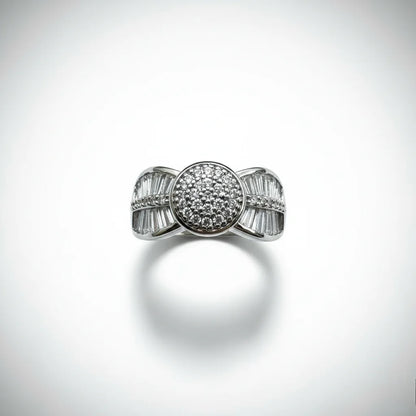 Silver ring with diamond accents on a light gray background
