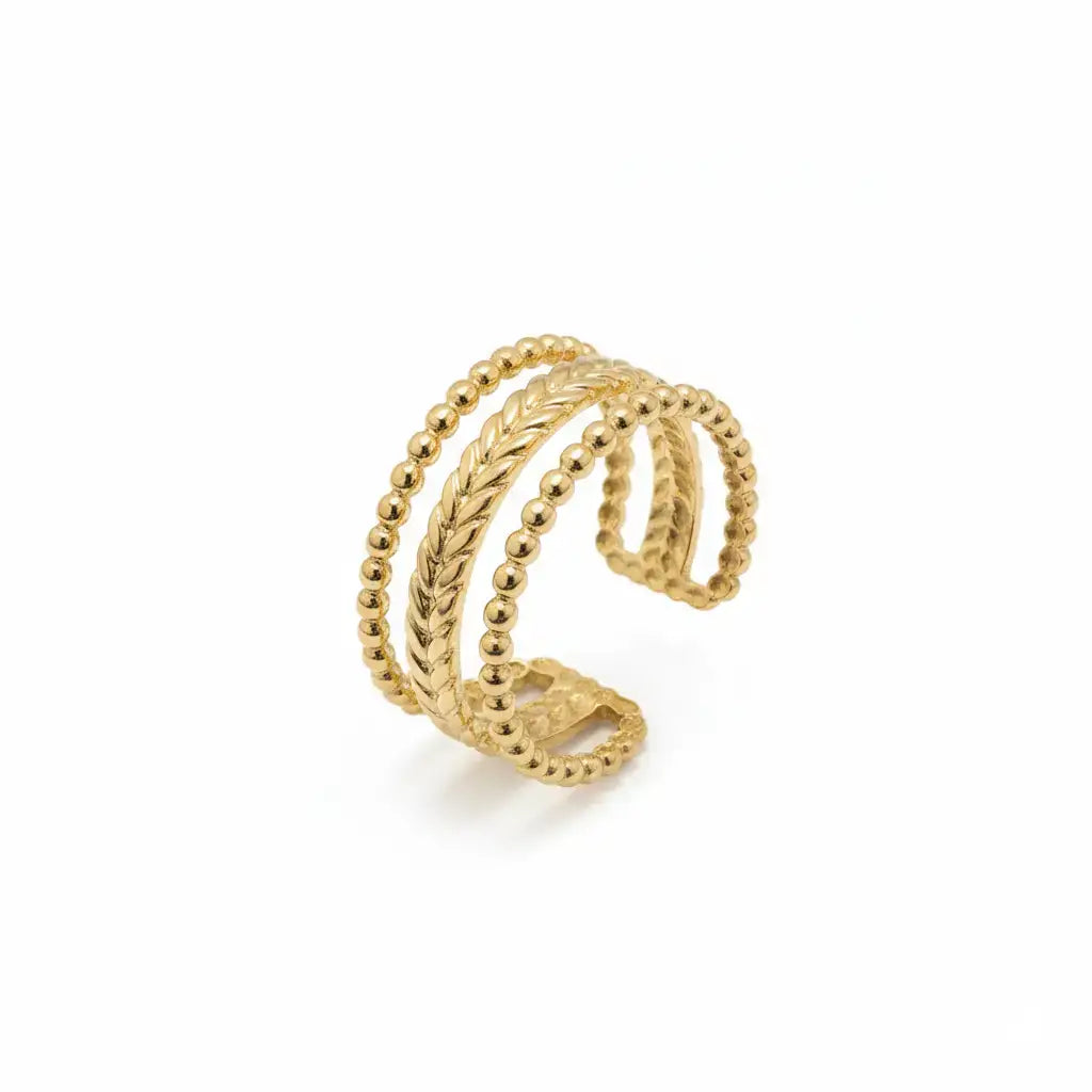 Gold ring with braided design on a white background