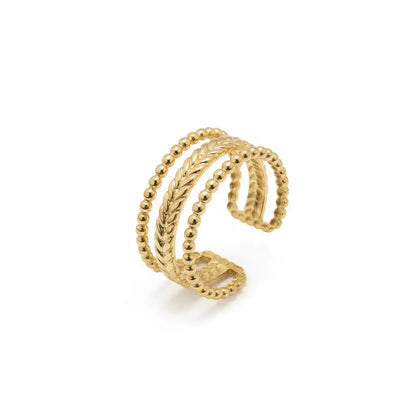 Gold ring with braided design on a white background