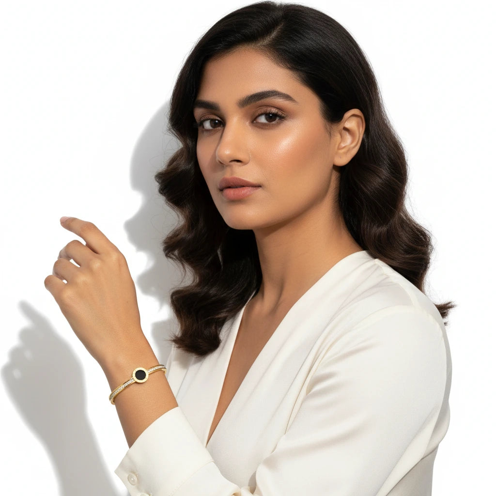 Woman wearing a white shirt with jewelry on a plain background