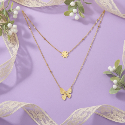 Gold butterfly and flower necklaces on a purple background with decorative ribbons and greenery.