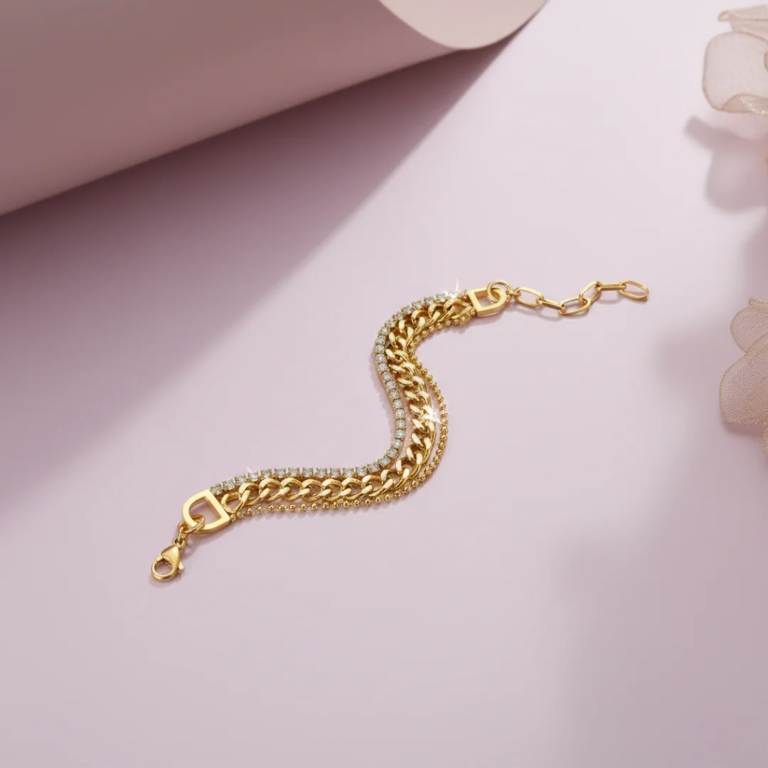 Gold chain bracelet on a light pink background