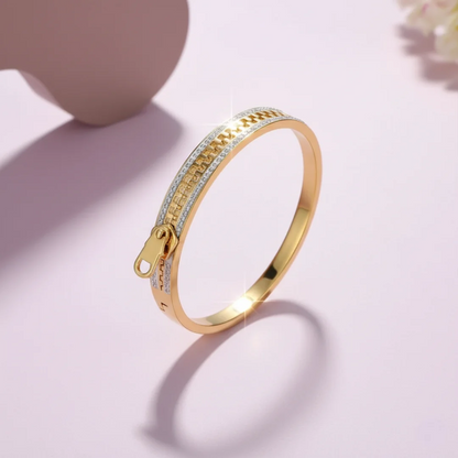 Gold bracelet with a unique design on a light pink background