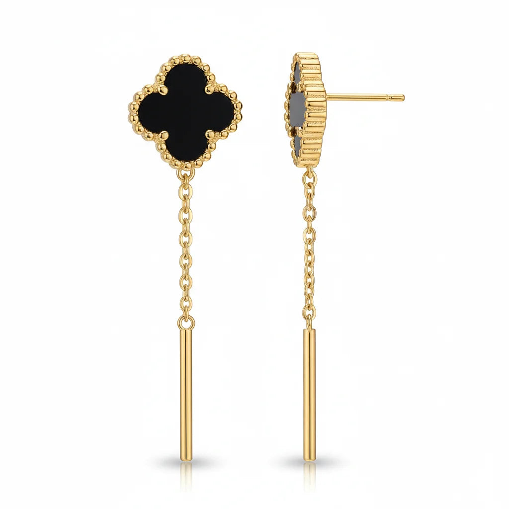 Gold earrings with black clover-shaped top and dangling gold bars on a white background