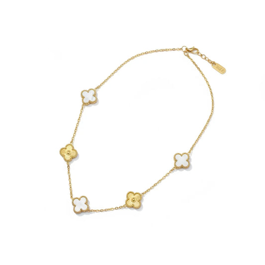 Gold necklace with clover-shaped pendants on a white background