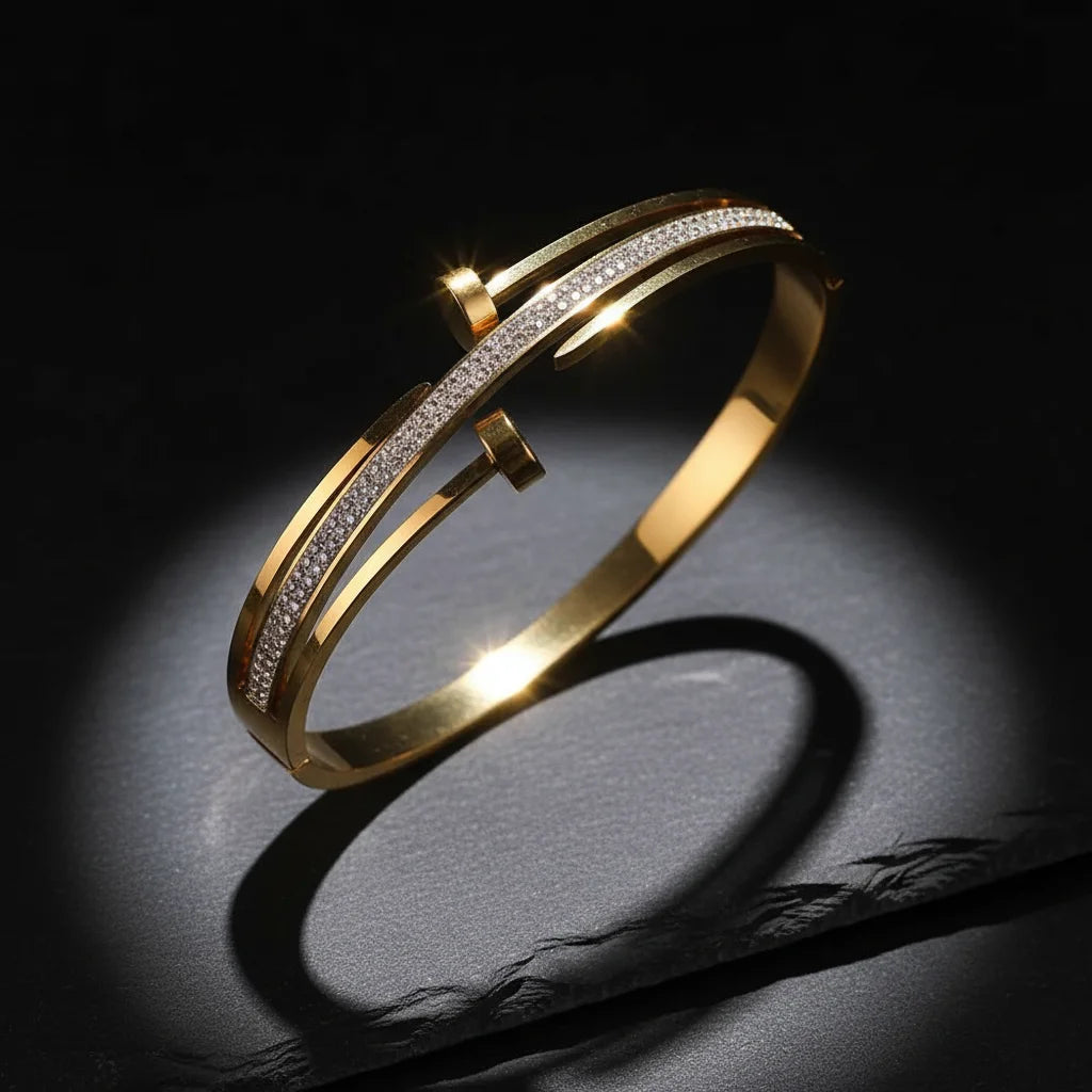 Gold bracelet with diamond accents on a dark background