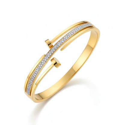 Gold bracelet with diamond accents on a white background