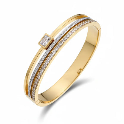 Gold bracelet with diamond accents on a white background