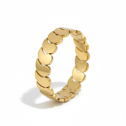 Gold chain-style ring on a white background