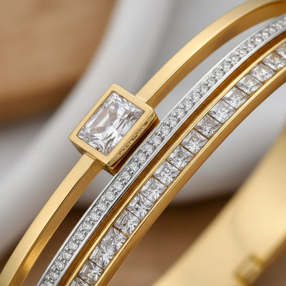 Gold bracelet with diamond accents on a neutral background