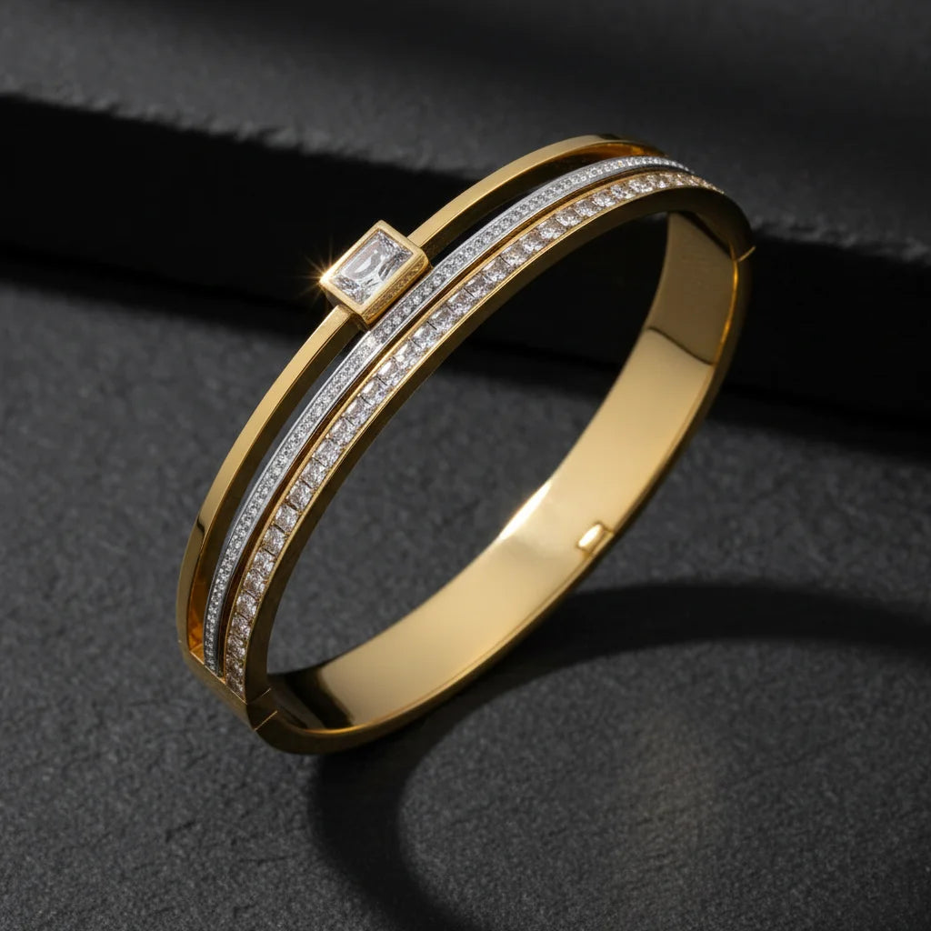 Gold bracelet with diamond accents on a dark background