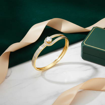 Gold ring with diamonds on a white surface with a green background