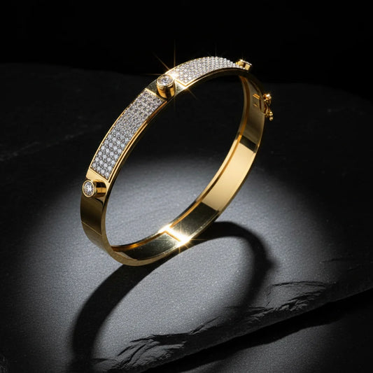 Gold bracelet with diamond accents on a dark surface