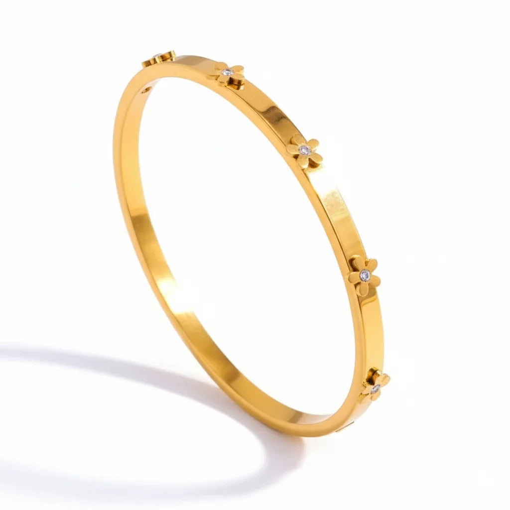 Gold bracelet with small diamonds on a white background