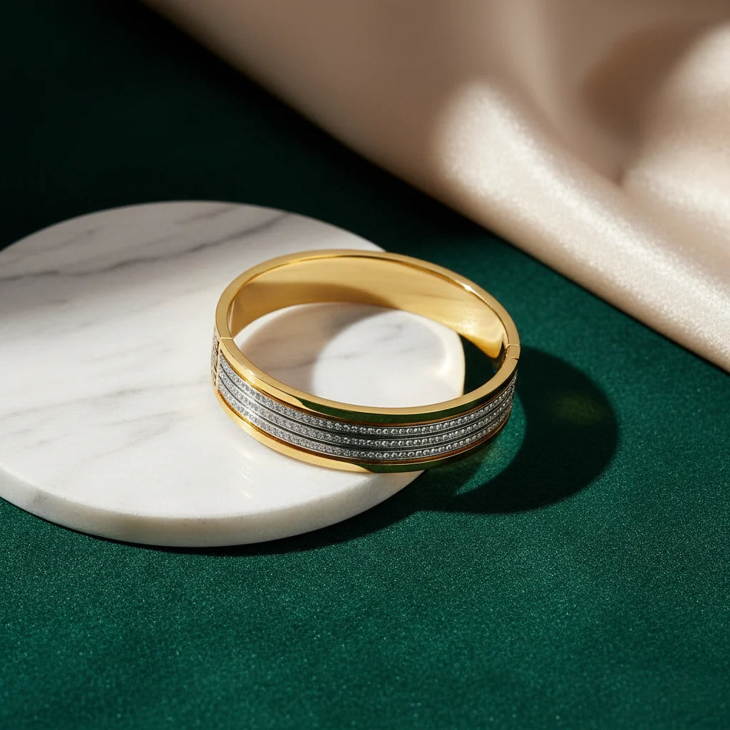 Gold ring with embedded diamonds on a marble surface with a green background