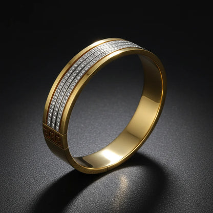Gold ring with diamond-studded band on a dark background