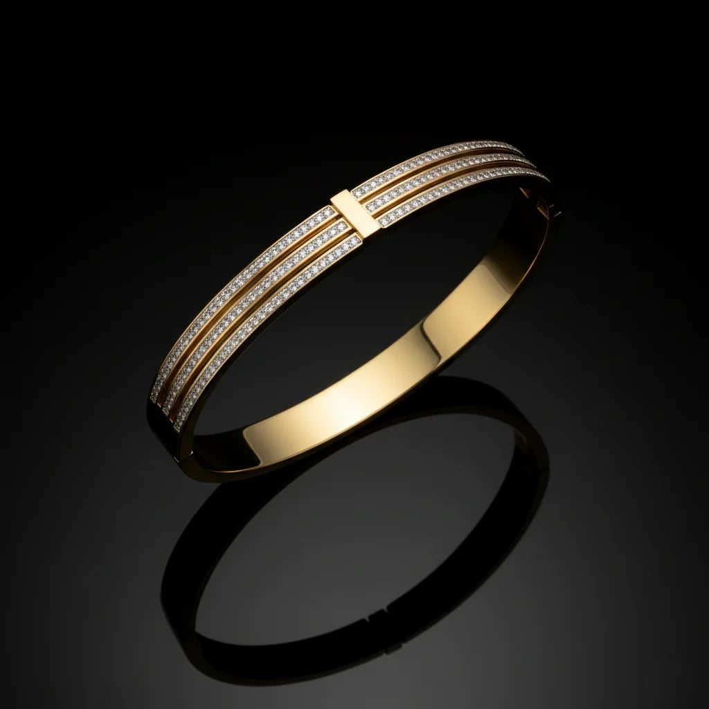 Gold bracelet with diamond accents on a black background