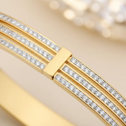 Gold bracelet with diamond accents on a light background