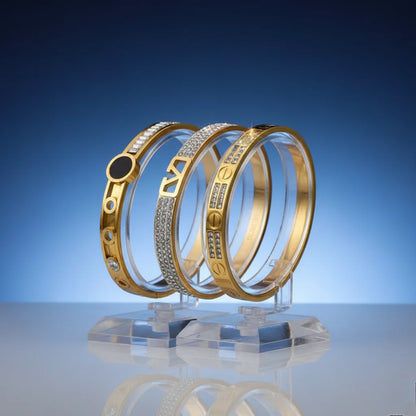 Three gold bangles with intricate designs on a reflective surface and blue background