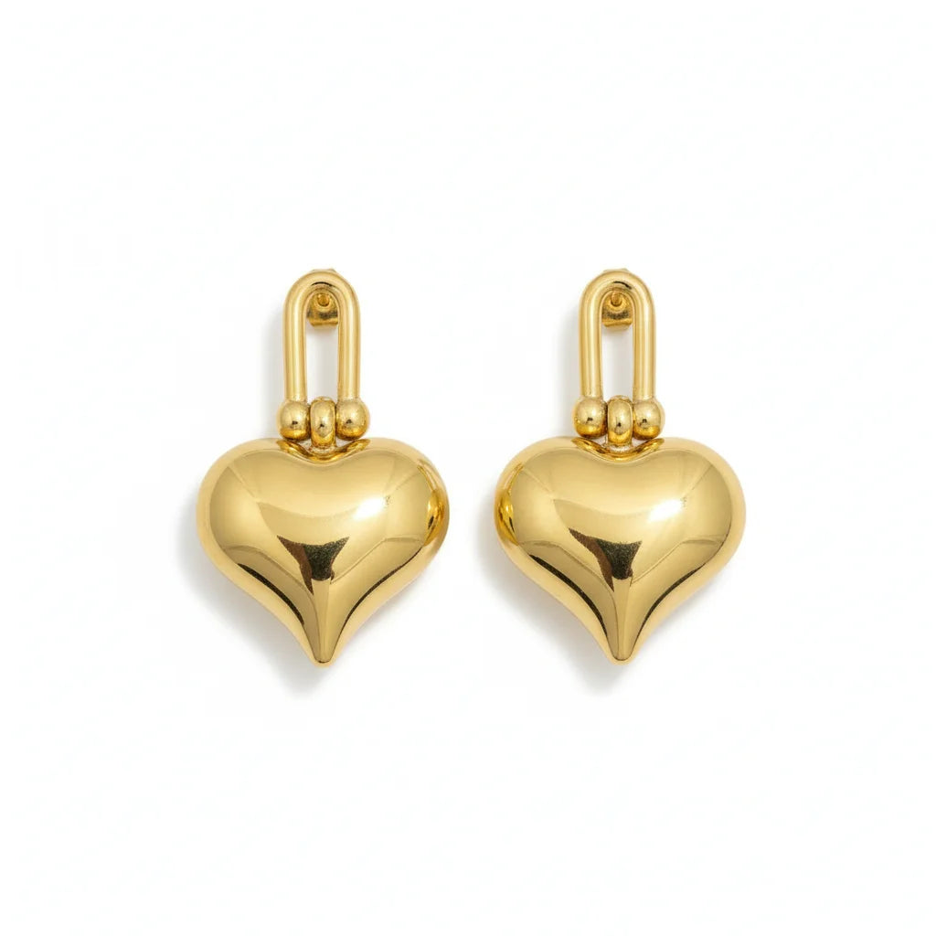 Gold heart-shaped earrings on a white background