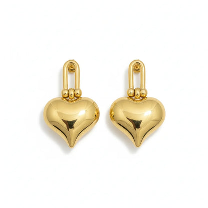 Gold heart-shaped earrings on a white background