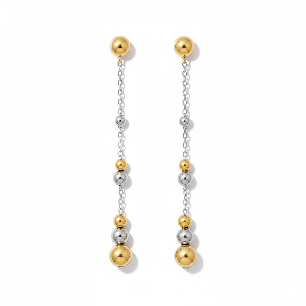 Pair of gold and silver beaded earrings on a white background