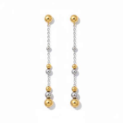 Pair of gold and silver beaded earrings on a white background