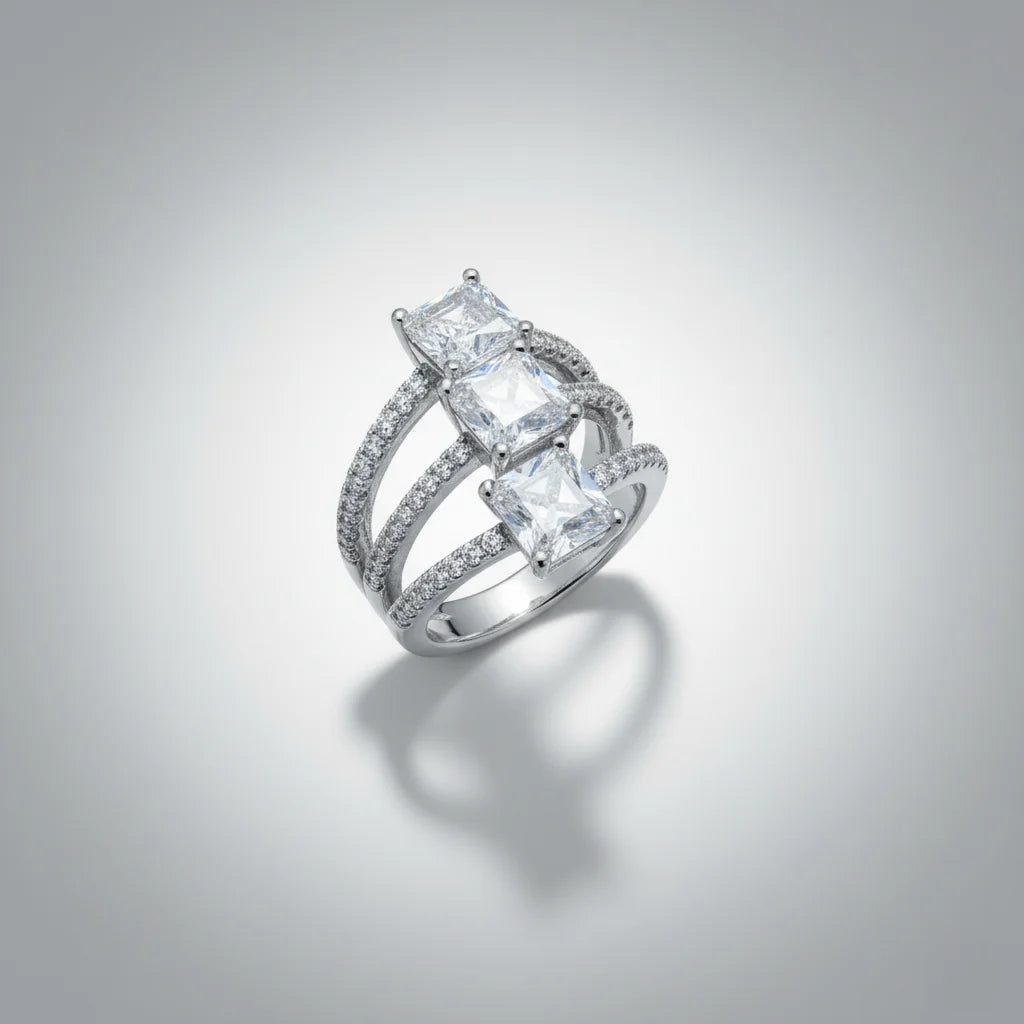 Silver ring with princess-cut diamonds on a gray background