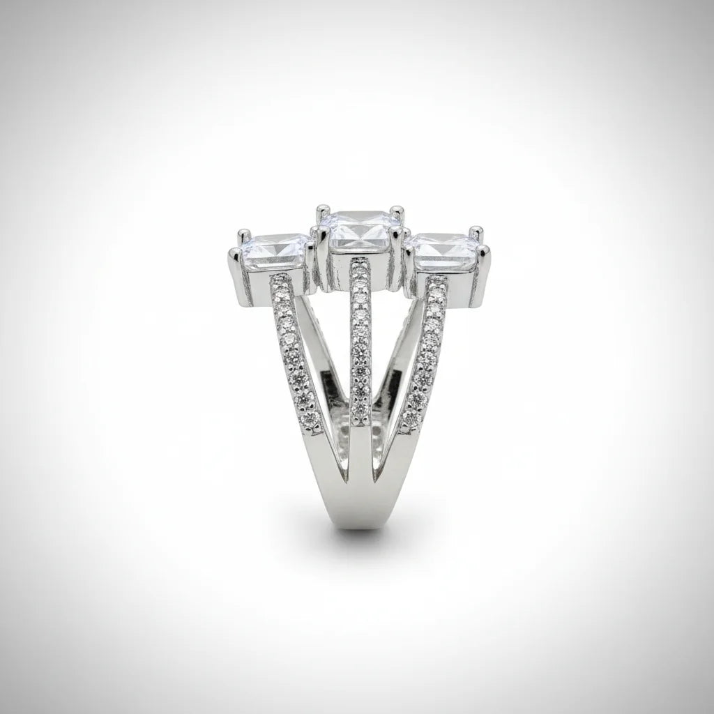 Diamond ring with three prominent stones on a white background