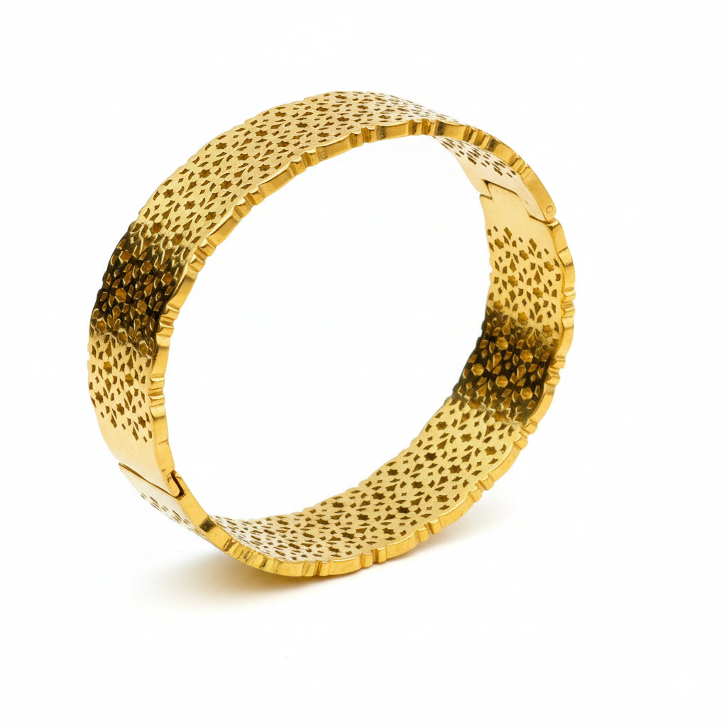 Gold bracelet with textured surface on a white background